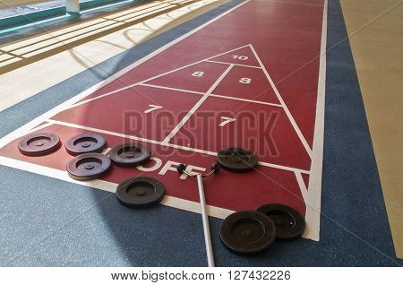 The shuffleboard game is ready to play on a cruise ship in the Caribean Sea