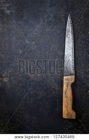 Old Knife on Rusty Metal Sheet