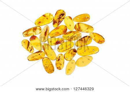 Yellow amber stones on a white background.