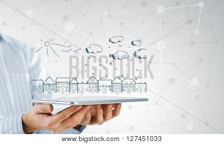 Hand of businessman demostrating tablet and construction concept on screen