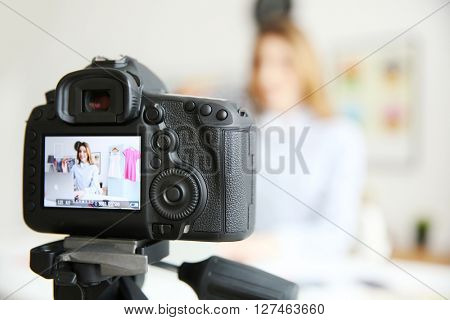 Young female blogger on camera screen