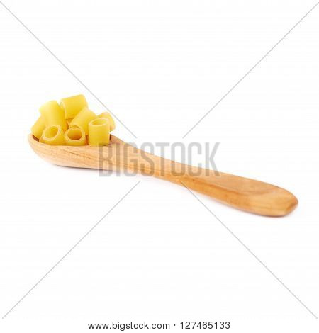 Wooden spoon filled with dry ditalini yellow pasta over isolated white background