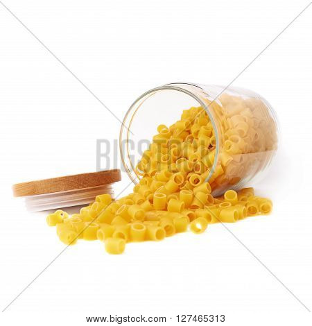 Glass jar filled with dry ditalini yellow pasta over isolated white background