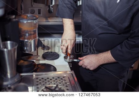 Close-up of barista grinding coffee.Barista prepares cappuccino in his coffee shop. Close-up cup of coffee.
** Note: Soft Focus at 100%, best at smaller sizes