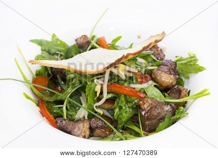 duck with arugula on a white background in the restaurant