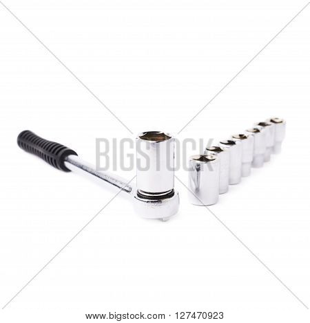 Wrench with line of metal sockets over white isolated background
