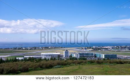 REYKJAVIK ICELAND - JUNE 27: Panorama of domestic Reykjavik airport and hotels nearby during summer on June 27, 2014.