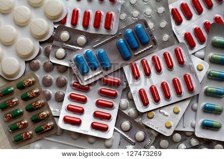 bright multicolored packs of pills background, horizontal view