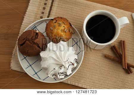Sweet breakfast in bed served on tray with coffee and cupcakes