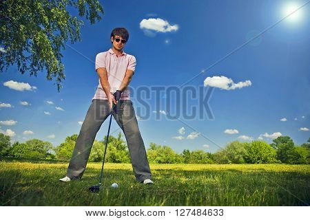 Golf player preparing to play a shot