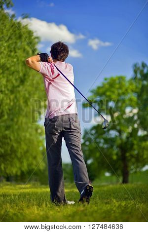 Golf player preparing to play a shot