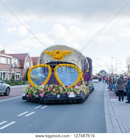 HILLEGOM, THE NETHERLANDS - APRIL 23, 2016: Moving platform with a frame made in a form of pilot sunglasses and cap. Taking part in the  traditional flowers parade 