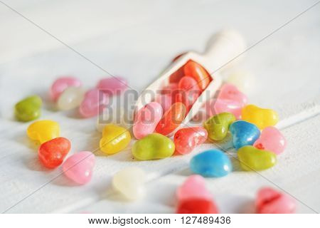 Colored pills in the kitchen measuring spoon.