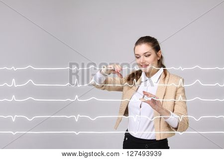Doctor woman working with cardiogram lines