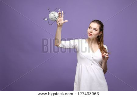 Woman scientist with atom model, research concept