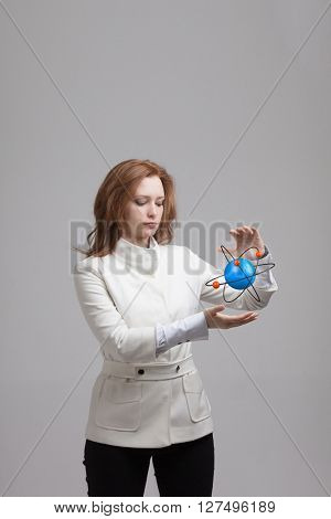 Woman scientist with atom model, research concept