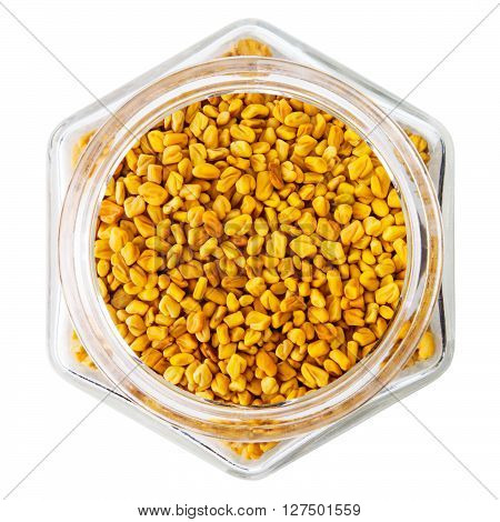 Fenugreek seeds in glass bottle, isolated on white  background