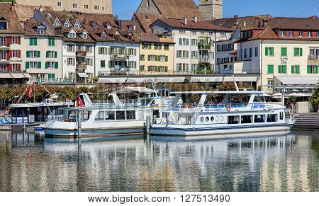 Rapperswil, Switzerland - 8 September, 2015: boats at pier on Seequai quay with old town buildings in the background. Rapperswil is a part of the municipality of Rapperswil-Jona in the Swiss canton of St. Gallen.