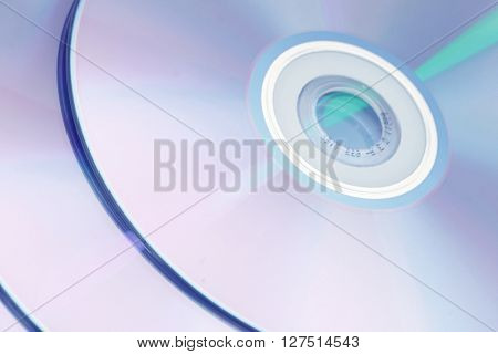 Photo of shiny underside of cd dvd cd-rom disk reflecting multicolors 