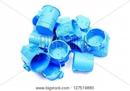 Heap of blue plastic electrical boxes on white background junction boxes accessories for engineering jobs