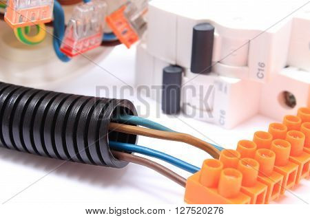 Corrugated plastic pipe cable with connection block and electric fuse copper wire connections components for use in electrical installations energy concept