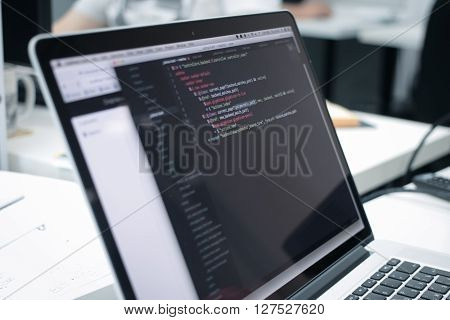 Web Developer's opened laptop with coding script
