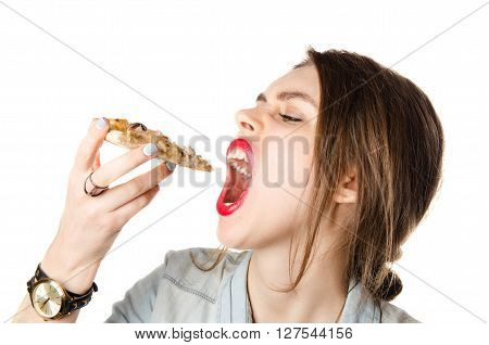 Pretty young sexy woman eating big slice of pizza with big opened mouth standing on white background