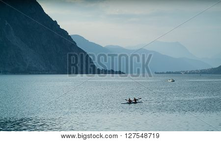 Lecco, Italy - September 1st 2015: Two canoe rowers photographjed at Lake Como near Lecco Italy on September 1st 2015.