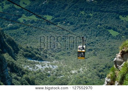 Piani d'Erna Italy - September 7th 2015: a yellow cable car carrying passengers down from Piani d'Erna (part of the Italian Alps)