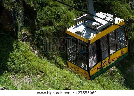 Piani d'Erna Italy - September 7th 2015: a yellow cable car carrying passengers down from Piani d'Erna (part of the Italian Alps)