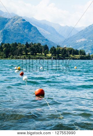 colorful buoys floating on Lake Como photographed from the area near Colico a town in north Italy