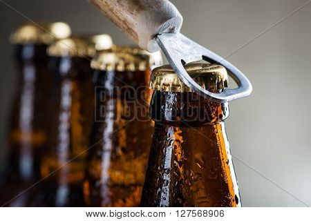 Brown Ice Cold Beer Bottles With Old Opener