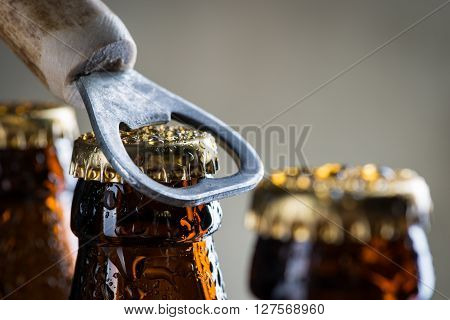 Brown Ice Cold Beer Bottles With Old Opener