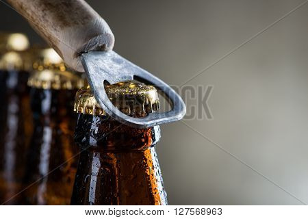 Brown Ice Cold Beer Bottles With Old Opener