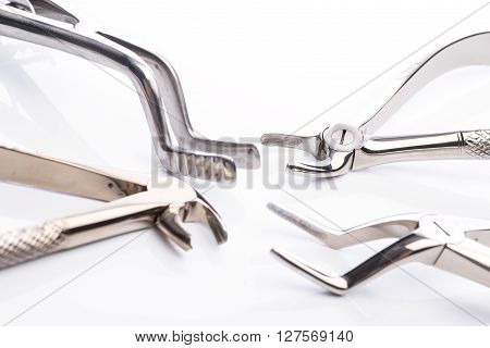 Pliers And Extraction Forceps On White Background