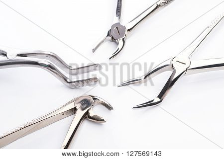 Pliers And Extraction Forceps On White Background