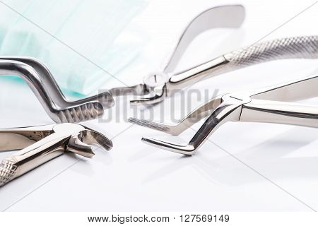 Pliers And Extraction Forceps On White Background
