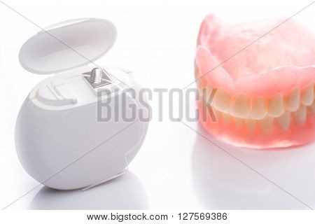 Teeth Model With Dental Floss On White Background