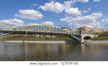 MOSCOW, RUSSIA - APRIL 24, 2016: Pedestrian bridge Bogdan Khmelnitsky or Kyivskiy pedestrian bridge over the Moscow River connects Berezhkovskaya and Rostovskaya embankments near Kievsky railway station