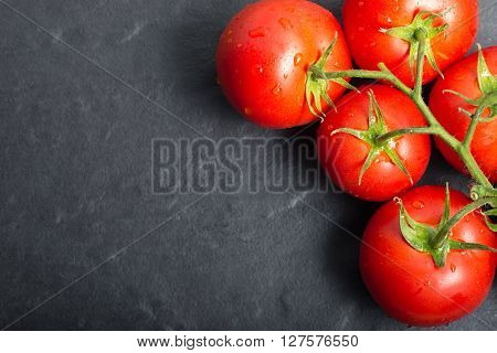 red tomatoes on stone background. red tomatoes