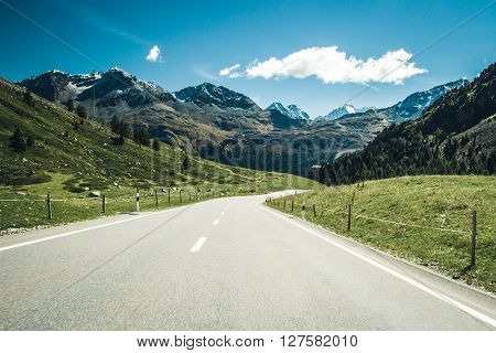 A scenic road through swiss Alps on a sunny day.
** Note: Visible grain at 100%, best at smaller sizes