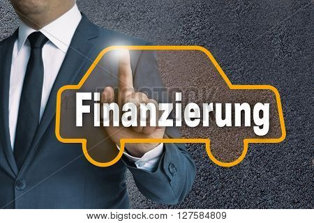 finanzierung (in german finance) car touchscreen operated by businessman concept.