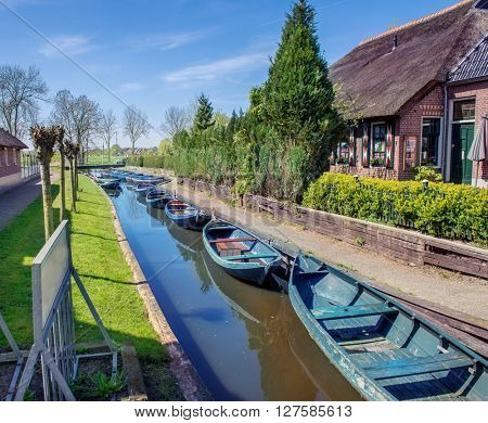 Boats in spring in Giethoorn, a small village in Overijssel province in the Netherlands. Part of the village has no car roads and some houses are accessible by boat only.