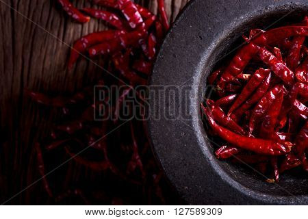 Red dried chili on wood background. (dark style)