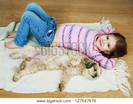 happy girl with her dog on the floor at home