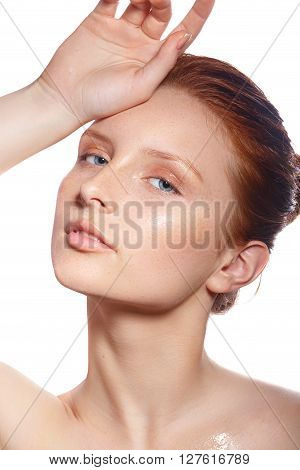 Beautiful Spa Woman Touching her chin. Youth and Skin Care Concept. Beautiful girl after a shower with wet hair and clean skin. Natural beauty. 
Fresh face