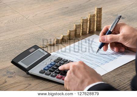 Close-up Of A Businessman Analyzing Financial Report