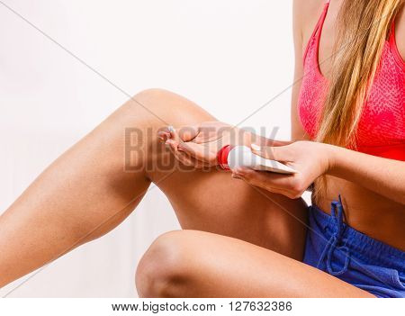 Woman Putting Ointment On Injury Knee Skin Care