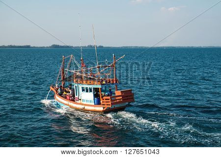 RAYONG, THAILAND - 2 JAN - Unidentified fishing boat with unidentified traveler passengers boating on ocean in Rayong, Thailand on January 2, 2016