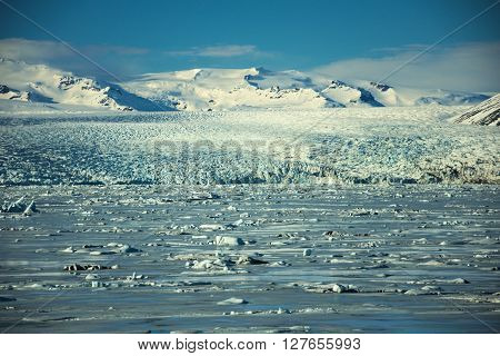 Impressive extensive glacier landscape Jökulsárlón  in front of blue sky